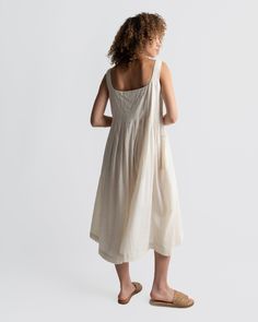 Introducing timeless white midi dress, showcasing contemporary details that align with our design ethos. Featuring a wide square neckline, pleats around the bust area gracefully cascading down to the hem, adding an elegant sophistication. Crafted from lightweight and fluid cotton fabric, it's the perfect choice for the summer season and can be easily dressed up or down for various occasions. Relaxed fit. Falls 45" from the shoulder. Scoop neckline. Pleated details. Made with Hand-woven cotton.? Eco Friendly Dress, White Midi, Conscious Fashion, Pleated Midi Dress, Mid Dresses, White Midi Dress, Woven Cotton, Tulle Dress, Summer Season