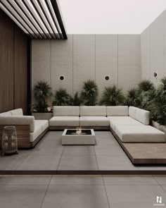 an outdoor living room with white couches and potted plants