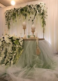 a table with flowers and candles on it