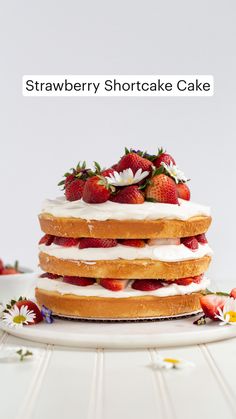 a stack of strawberry shortcakes with icing and strawberries on the top