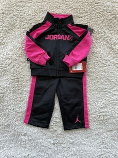 NWT  NikeJordan Jumpman Baby Toddler 2pc Jacket Pants Set Size 12M MSRP $ 60 Excellent condition Brand Nike Jordan Color Black/Pink Department Baby Size 12M 75-80cm Type outfit/Set Style Jacket/Pants Clothing, Shoes & Accessories>Baby>Baby & Toddler Clothing> Outfits & Sets Jacket: Shoulder 8 Bust 10 Front Length 10.5 Bottom Hem 10 Sleeve Length 10 Pants: Hips 9.5 Inseam 9 Outseam 14.5 Waist 8.5 Pay attention to pictures and measurements!  Please read details and view all pictures before bidding Pink Long Sleeve Sets For Winter, Nike Sets For Winter Playwear, Pink Long Sleeve Winter Sets, Nike Long Sleeve Sets For Winter, Nike Long Sleeve Winter Sets, Pink Fall Tracksuit For Sports, Sporty Nike Winter Sets, Nike Sporty Winter Sets, Fitted Pink Tracksuit For Sports