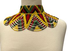 Add a touch of culture and beauty to your outfit with this authentic African ethnic collar choker necklace. The necklace features a stunning array of multicoloured beads that are handcrafted to perfection, giving it a unique and eye-catching appeal. Its beaded design consists of a combination of choker and collar styles that sit comfortably around your neck to complement any attire. This necklace is perfect for anyone who loves to explore different cultures and appreciates handmade jewelry. It i Colorful Adjustable Traditional Necklaces, Multicolor Traditional Bib Necklace With Large Beads, Traditional Festival Choker With Large Beads, Traditional Multicolor Fair Trade Jewelry, Multicolor Fair Trade Festive Jewelry, Traditional Handmade Multicolor Beaded Necklaces, Traditional Large Beads Bib Necklaces For Festivals, Traditional Large Beads Bib Necklace For Festivals, Traditional Large Bead Choker Necklace