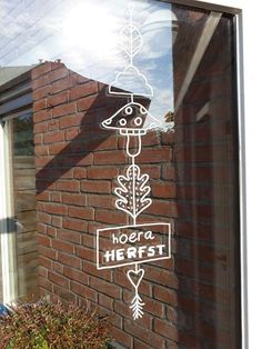 a brick building with a sign that says herest in front of it and an arrow drawn on the side