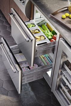 an open refrigerator in a kitchen with fruits and vegetables