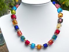 A great multicolored necklace, to go with all your outfits!Venetian bead foil cubes, Murano glass necklace, 11mm handmade, lamp worked, multicolored, Italian cubes, gold filled chain and large lobster style clasp.The necklace shown in the photos is 17 inches, (43.18cm.), adjustable to 19 inches, (48.26 cm.),  with adjustable gold filled link chain and lobster style, gold filled clasp; $149.00.I also offer this necklace in a longer length, by adding more handmade, 11mm foil cubes, more bead caps, Elegant Handmade Colorful Necklaces, Elegant Colorful Handmade Necklace, Handmade Lamp, Murano Glass Necklaces, Autumn Necklace, Silver Link Chain, Cube Beads, Bead Caps, Glass Necklace