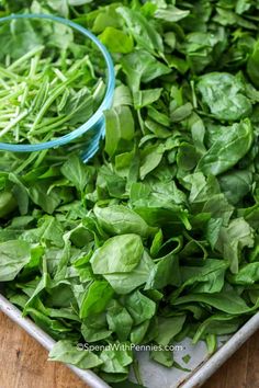 fresh spinach leaves on a tray ready to be cooked in the oven for dinner