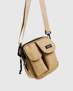 a beige bag with two pockets hanging from it