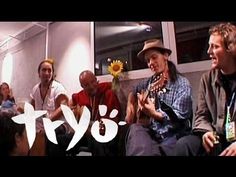 several people sitting in a room with the words tyo written on them and sunflowers