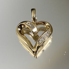 "14KY Gold heart shaped pendant (11x) 0.007ct Diamond straight baguettes Diamond Total Weight .08ct Clarity I1 Color I --------------------------------------------- All jewelry at Callie's Treasure Shop is sold in \"as-is\" condition. Most of the jewelry is vintage and previously worn. Our team inspects and cleans all jewelry before listing for sale. If it isn't up to our standards, it doesn't get listed! Please send us a message if you have any questions or concerns and we will do our best to a Heart-shaped Baguette Diamond Jewelry For Anniversary, Heart Shaped Baguette Diamond Jewelry For Anniversary, Heart Cut Baguette Diamond Jewelry For Anniversary, Heart Cut Baguette Diamond Jewelry Gift, Anniversary Heart Cut Baguette Diamond Jewelry, Heart-shaped Baguette Diamond Jewelry For Gift, Heart-shaped Baguette Diamond Jewelry Gift, Horseshoe Pendant, Heart Shaped Pendant