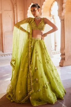 Lime green organza lehenga with hand block print highlighted with delicate thread work. Paired with an embellished blouse and dupatta.
Components: 3
Pattern: Embroidered
Type Of Work: Sequin
Neckline: Leaf
Sleeve Type: Sleeveless
Fabric: Blouse: Net, Lehenga: Organza Silk, Dupatta: Net
Color: Green
Other Details: 
Length:
Lehenga: 44 inches
Occasion: Wedding, Mehendi and Haldi - Aza Fashions Green Organza Lehenga, Indian Wedding Dress Traditional, Pleated Organza, Mehndi Outfits, Organza Lehenga, Vacuum Storage, Indian Wedding Wear, Mehandi Design, Lehenga Blouse