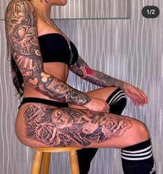 a woman sitting on top of a stool with tattoos on her leg and arm,