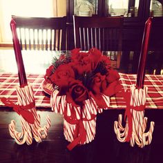 the table is decorated with red roses and candy canes