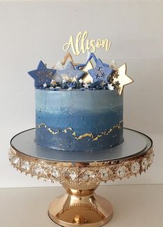 a blue and gold cake with stars on top is sitting on a plate that says, allison