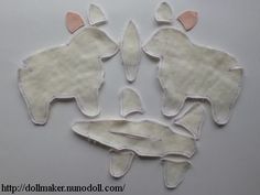 three pieces of cloth with ears and tails cut out on a white tablecloth background