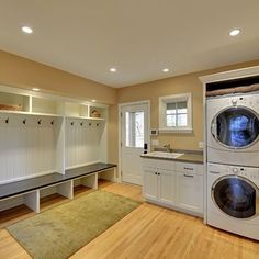 an image of a laundry room with washer and dryer on the right side