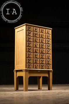 an old wooden dresser with drawers on it's legs and the letter i - a