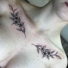 a woman's chest with flowers and leaves tattooed on her left side ribcage