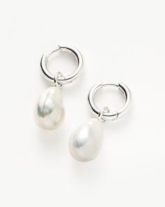 Baroque Pearl Drop Tunnel Mini Hoop Earrings | Sterling Silver Sterling Silver/Pearl. Introducing an Elevated Collection of Everyday Essentials that are Anything but Basic. Our Best Selling Baroque Pearl Earrings, Now Featuring Tunnel Mini Hoops. They Also Have a Hidden Hinge for a Seamless Closure. Two Earring Styles in One, Remove the Charm to Wear the Mini Hoops on their Own for a Simple Statement. Metal: Rhodium Plated on Recycled Sterling Silver Gemstone: Pearl Hoop Dimensions: 13. 5mm X 13