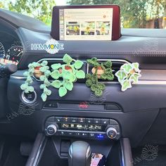 the dashboard of a car with plants and other decorations on it's dash board