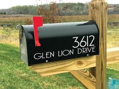 a black mailbox sitting on top of a wooden post