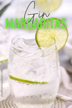 a glass filled with water and lime on top of a table