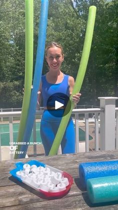 a woman standing next to two inflatable objects