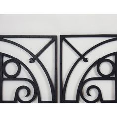 two black metal wall art pieces on a white background, each with an intricate design