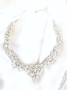 *Photo Credit: www.madlyphoto.com & Instagram: @madly_photo If you are searching for a statement bridal necklace that will make you feel like royalty, then this incredibly detailed Swarovski Rhinestone collar necklace is surely the one! Each stone is hand placed onto the design for a truly one of a kind, handmade statement bridal necklace. The details in this piece are nothing short of amazing. Totaling 6 hours of design time, this piece of art is exquisite and will complete your bridal look Diamond Bridal Necklace With Rhinestones For Wedding, Dazzling Rhinestone Necklace With Diamond Accents For Wedding, Crystal Bridal Necklace With Rhinestones For Wedding, Glamorous Diamond Rhinestone Necklace For Wedding, Dazzling White Rhinestone Necklace For Wedding, Glamorous Diamond Bridal Necklace For Wedding, Glamorous Diamond White Rhinestone Necklace For Weddings, Bridal Rhinestone Necklace For Wedding, Dazzling Diamond White Rhinestone Necklace For Wedding