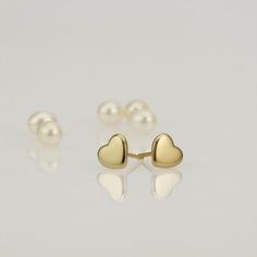 These are small gold heart stud earrings, handmade of 14k solid gold.Modern yellow gold Heart earrings, with a highly shiny finish.These heart studs are perfect for every day’s wear, and will look great with any style.They will add a chic gold touch and sparkle to your appearance.A wonderful gift for yourself or for someone you love. Heart’s size is approx 6.8 x 6.2 mm = 0.26 x 0.24 inch Heart is 1.4 mm thick = 0.05 inch.14k solid gold ear backs are included.*I can make these earrings in matte f Minimalist Gold Heart Earrings With Charm, Dainty Yellow Gold Heart Earrings For Everyday Wear, Minimalist Gold Hypoallergenic Heart Earrings, Delicate Gold Heart Earrings For Everyday, Tiny Dainty Yellow Gold Heart Earrings, Dainty Tiny Yellow Gold Heart Earrings, Dainty Yellow Gold Sterling Silver Heart Earrings, Tiny Heart-shaped 14k Gold Earrings, Delicate Gold Hypoallergenic Heart Earrings