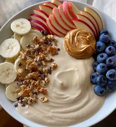 a bowl filled with yogurt, fruit and nuts