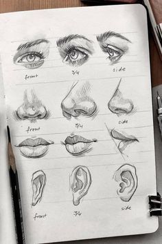 an open notebook with various types of eyes and nose drawn on paper next to pens