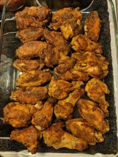 chicken wings and other food items on a tray