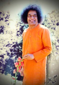 a man in an orange outfit holding a flower