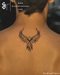 the back of a woman's neck with a bird tattoo on her left side