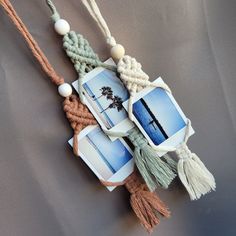 some pictures are hanging on a string with tassels