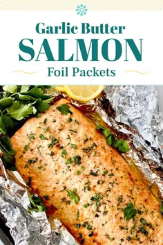 grilled salmon fillets in foil with lemon wedges and herbs on the side