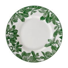 a green and white plate with leaves on it