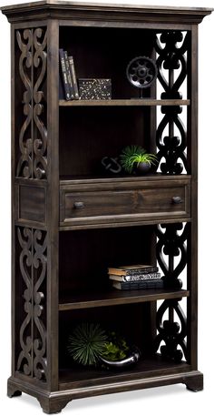 an ornate bookcase with drawers and shelves