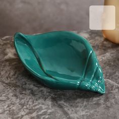 a green bowl sitting on top of a table