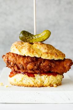 a chicken sandwich with pickles on top