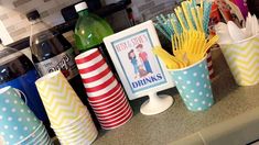 there are many cups that have drinks in them on the counter with some straws