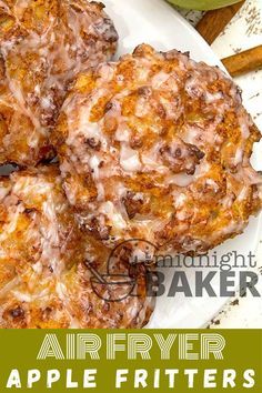 four apple fritters sitting on top of a white plate