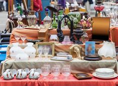 a table topped with lots of dishes and glasses