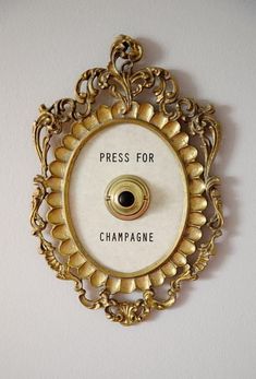 a clock with the words press for champagne on it