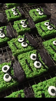 green and black decorated cookies with eyes on them