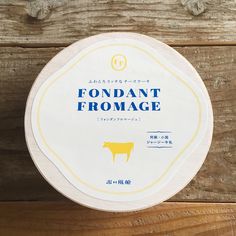 the label for fondant fromage on a wooden surface