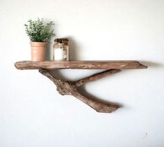 a wooden shelf with a potted plant on it