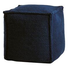 a blue poufce ottoman sitting on top of a white floor