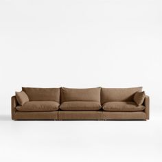 a brown couch sitting on top of a white floor