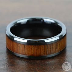 This black ceramic band frames an 8-millimeter inlay of reused koa wood creating an striking men's ring. Koa Collection. Luxury Men's Ring With Unique Inlay, Luxury Men's Round Ring With Inlay, Luxury Men's Ring With Inlay, Luxury Men's Inlay Jewelry, Luxury Men's Ring With Inlay For Gift, Luxury Elegant Men's Ring With Inlay, Luxury Men's Anniversary Ring With Inlay, Luxury Inlay Men's Ring As A Gift, Luxury Men's Inlay Rings